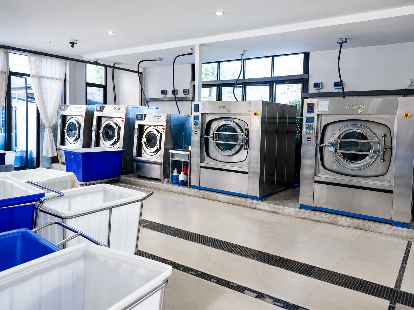 Industrial washing machines processing high-volume hotel linen at Concept Laundry in Phuket